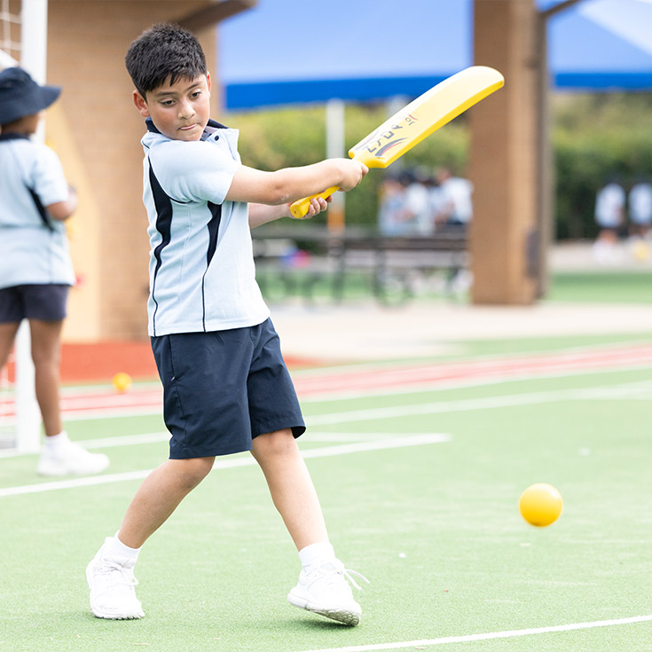 Student playing cricket